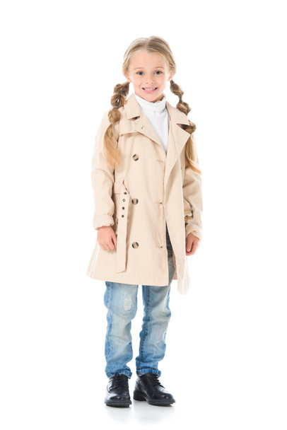 adorable kid posing in beige coat, isolated on white - Фото, изображение
