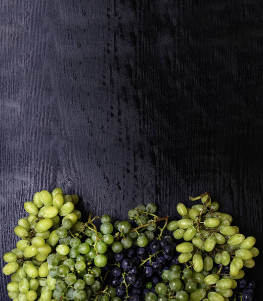 Mix of Fresh grapes on the boards, tasty food, rich of resveratrol - Photo, Image