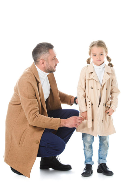 stylish father and daughter in beige autumn coats, isolated on white - 写真・画像