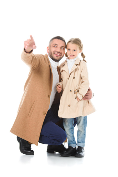 father showing something to stylish daughter in autumn outfit, isolated on white - Zdjęcie, obraz