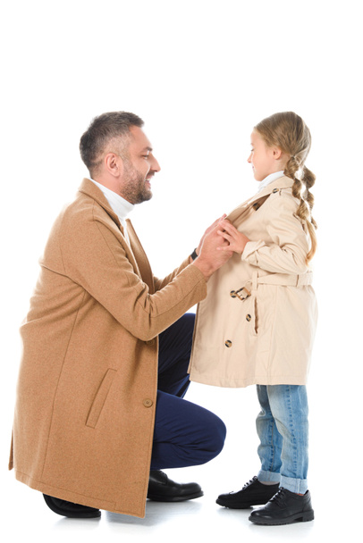 stylish father and daughter wearing beige coats, isolated on white - Фото, зображення