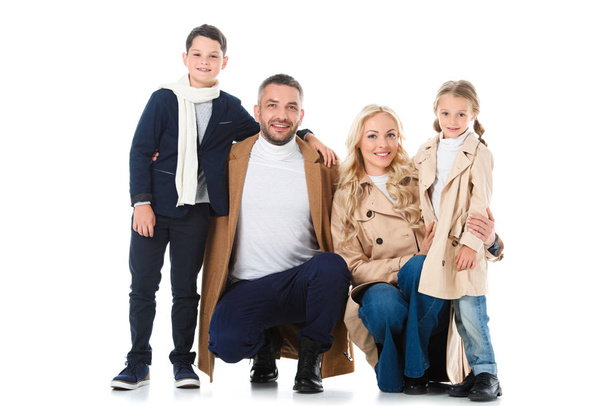 stylish family hugging with kids in beige coats, isolated on white - Photo, Image