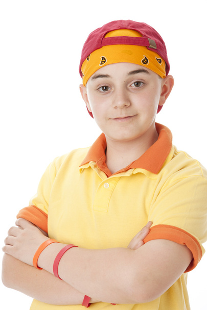 Real. Smiling caucasian teenage boy waring a colorful baseball cap and bandana - Photo, Image