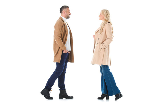 smiling couple posing in trendy beige coats, isolated on white - Fotoğraf, Görsel