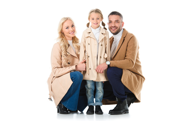 beautiful parents with adorable daughter in beige coats, isolated on white - Zdjęcie, obraz