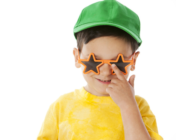 Real. Hispanic little boy wearing bright clothes with a baseball cap and silly sunglasses - Fotografie, Obrázek