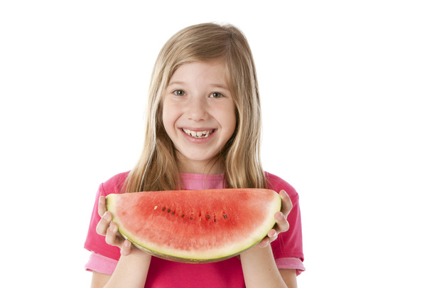 Healthy Eating. Caucasian little girl holding a big juicy piece of fresh watermelon - 写真・画像