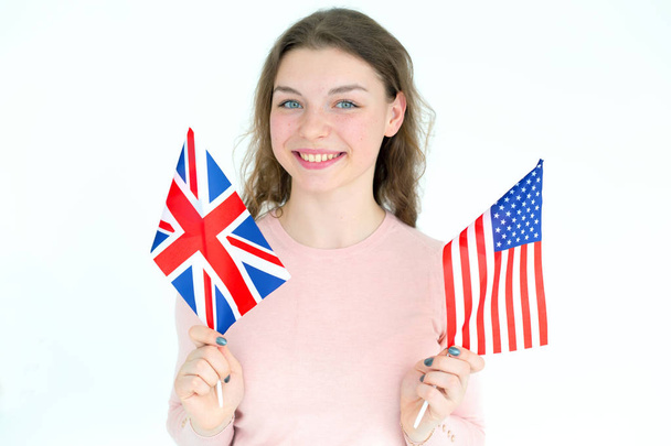 Young woman with flags of the USA and UK. Learn English. - Foto, Bild