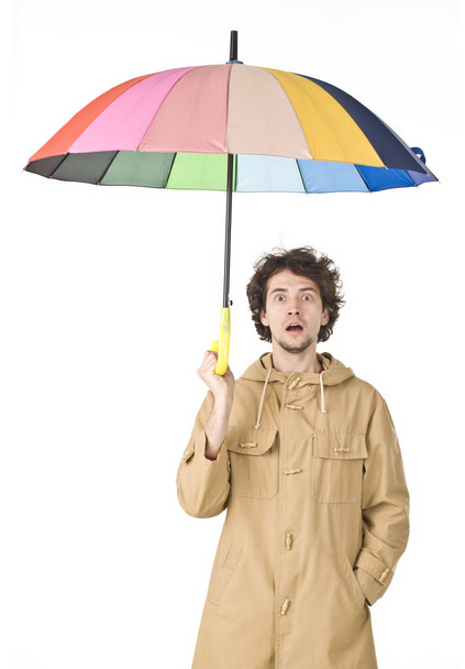 Man wearing in raincoat pointing his umbrella - Foto, afbeelding