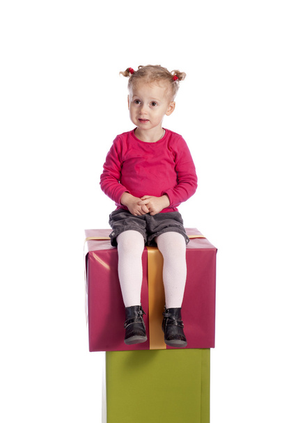 little girl sitting on presents - Foto, Bild