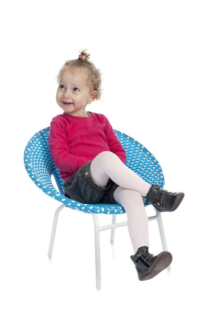 cute little girl sitting in a round blue chair - Φωτογραφία, εικόνα