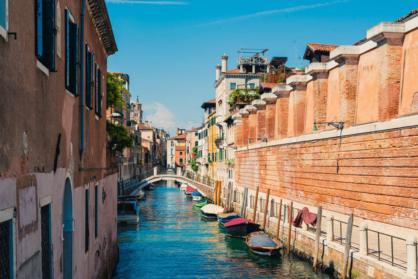 Traditional canal street with boats in Venice, Italy. - 写真・画像