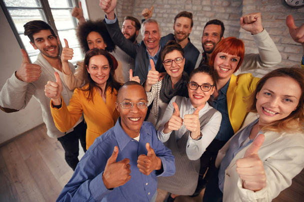 Businessman and businesswoman team giving thumb up sign of success business teamwork concep - Фото, изображение