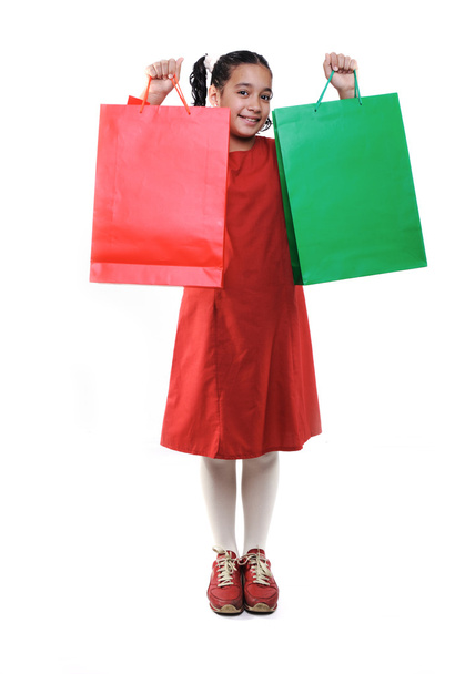 Little girl with shopping bags and boxes, isolated - Foto, afbeelding