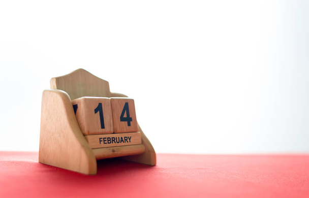 valentine's day concept. wooden calendar 14 February with soft-focus and over light in the background - Valokuva, kuva