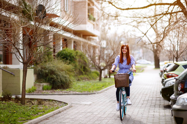 Young female cycling bike in town - Fotó, kép