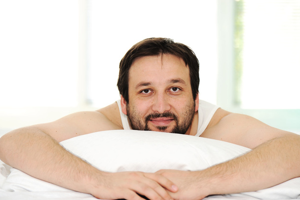 Man in sleeping bed, morning time - Photo, image