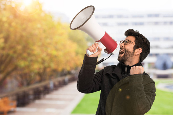 young man holding a megaphone - Foto, afbeelding