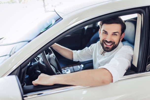 portrait of happy businessman sitting in the car and looking at the camera - Foto, Imagem
