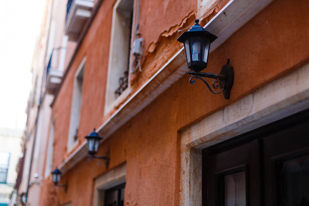 Street lamp on a red wall background. Wall with street lamp. - 写真・画像