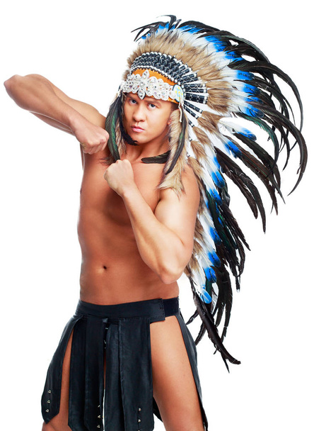 handsome muscular young man wearing a Native American costume - Φωτογραφία, εικόνα
