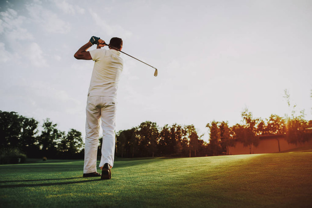 Young Man in White Clothes Playing Golf on Field. Relaxing in Golf Club. Sports in Summer. Outdoor Fun in Summer. Happy Young Man. Healthy Lifestyle Concept. Man it White Shirt. Green Grass. - Photo, Image
