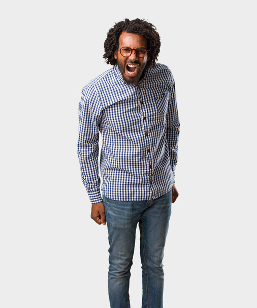 Handsome business african american man screaming angry, expression of madness and mental instability, open mouth and half-opened eyes, madness concept - Фото, изображение