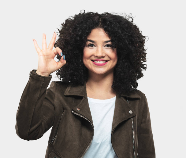 young woman doing ok gesture - Фото, изображение