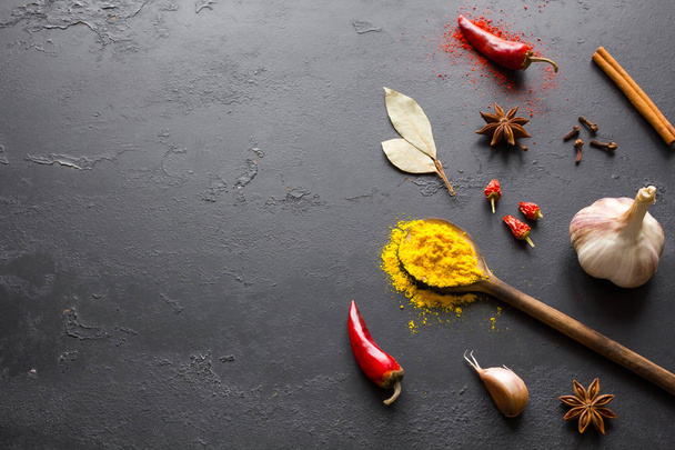 spices and herbs for cooking on a black background with space for text - Fotó, kép