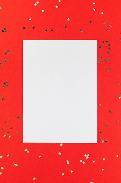 Creative New Year or Christmas greetings letter mockup flat lay top view Xmas holiday celebration envelope on red paper background golden glitter. Template mock up greeting card text design 2019 2020 - Zdjęcie, obraz