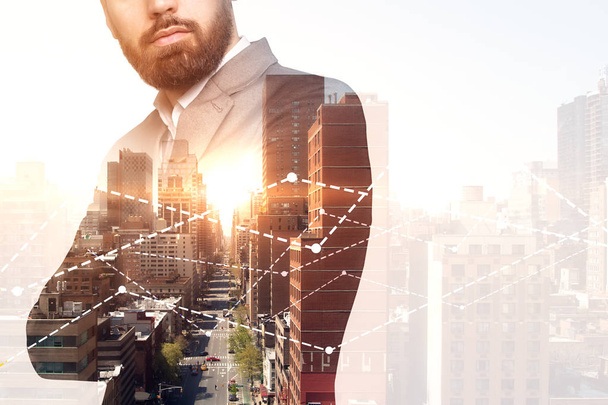 Unrecognizable bearded businessman in suit and tie standing crossed arms against graphs over morning cityscape. Stock market and fintech concept. Toned image double exposure copy space - Photo, Image
