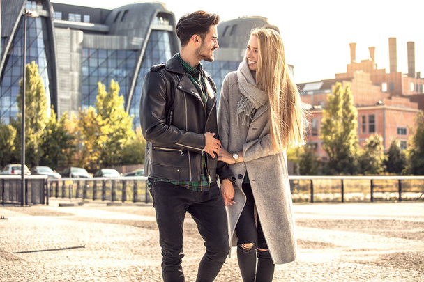 Young couple dating in the city. Blonde beautful woman and handsome man in fashionable clothes , autumn season. - Fotoğraf, Görsel