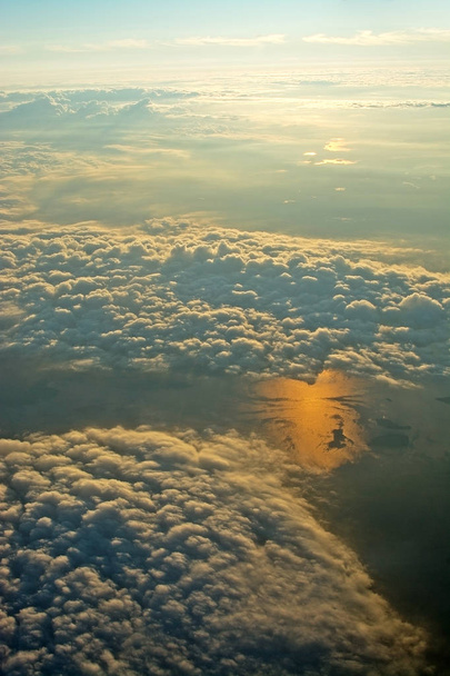 Aerial abstract landscape view over clouds and sun reflection in water at sunset in a summer evening near Stockholm, Sweden. - Photo, Image