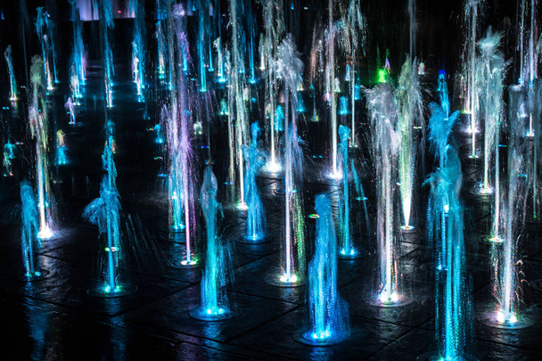 A colored fountain with illumination at night. A fabulous fountain. Background. - Photo, Image