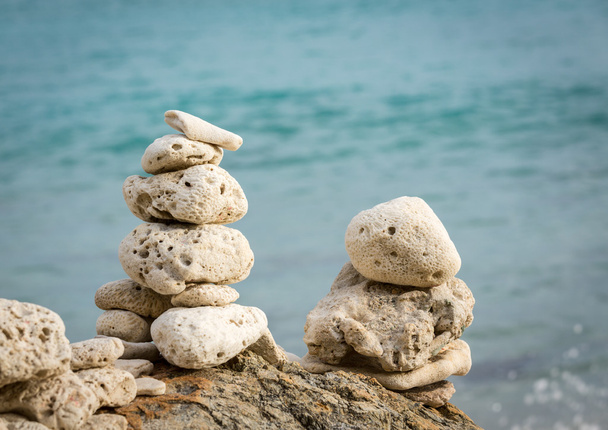 Stack of pebbles by ocean seaside - Photo, Image