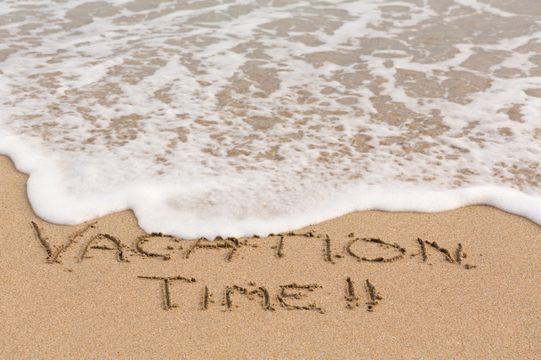 Vacation Time written in sand with sea surf - Photo, Image