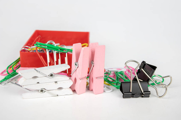 Office supplies on a white table. Paper clips and clips for office use. White background. - Φωτογραφία, εικόνα