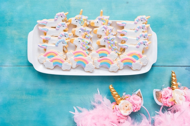Unicorn sugar cookies decorated with royal icing on a blue background. - Photo, Image