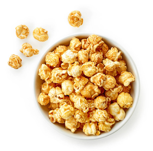 bowl of caramel popcorn isolated on white background, top view - Zdjęcie, obraz