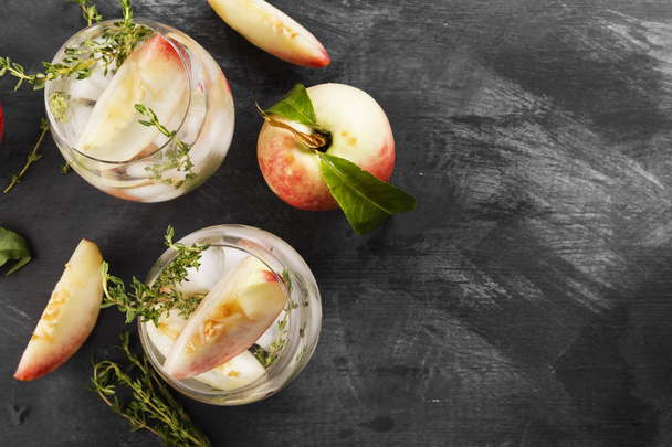 Peach lemonade with thyme on a dark background. Top view, copy space. Food background - Фото, зображення