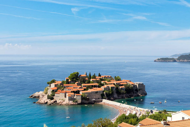 View of the island of Sveti Stefan on a sunny day, the end of September - Фото, изображение