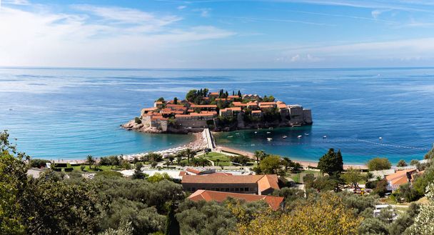 View of the island of Sveti Stefan on a sunny day, the end of September - Фото, изображение