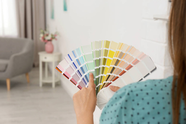 Female interior designer with color palette samples indoors - Valokuva, kuva