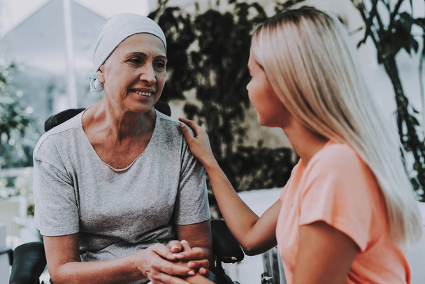 Patient Undergoes Rehabilitation. After Treatment for Cancer. Cancer Patient on a Wheelchair. A Woman with Daughter. Woman Glad See Daughter. Recovering Woman. Remission. Clinic. Cancer Patient. - Foto, Imagen