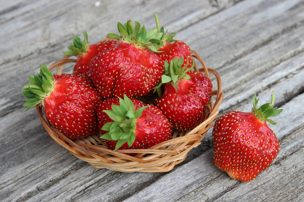Ripe organic strawberries on the background of boards. Agriculture - Photo, Image