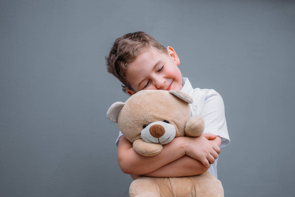 Safety concept. The boy is holding teddy bear - Foto, Imagem