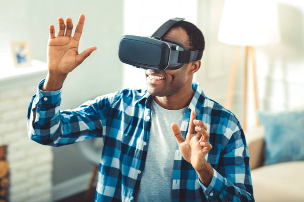 Positive young afro american man building VR - Фото, изображение
