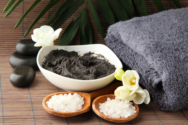 Composition with cosmetic clay for spa treatments, on bamboo background - Фото, зображення
