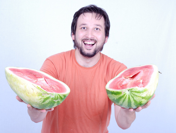 Caucasian man offers a watermelon - Foto, imagen