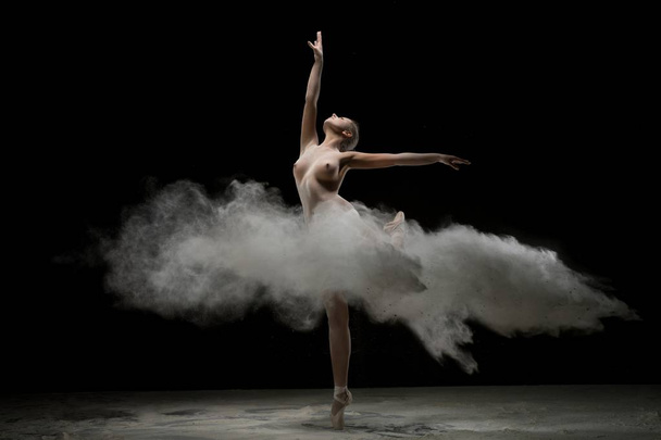 Girl topless in pointe in a burst of white powder - Photo, Image